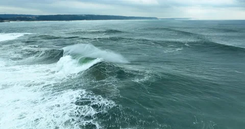 Aerial view of powerful dark ocean waves rolling from above. Drone flying over Stock Footage 221788082