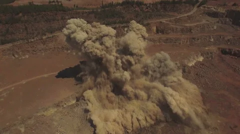 Aerial view. Powerful explosion on the open pit mine. Extreme drone shot. 4K Stock Footage