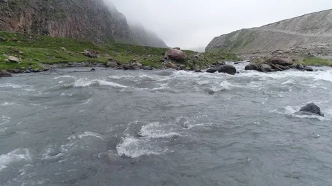 Aerial view of powerful mountain stream on very low altitude. Stock Footage 91016211