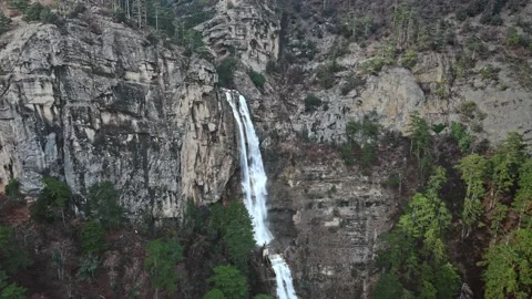 Aerial view of the powerful mountain waterfall in cloudy weather Stock Footage 148482459