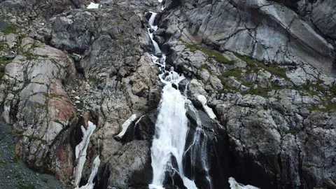 Aerial view of powerful multi-tiered waterfall cascading down steep rocky cliff Stock Footage 335093782