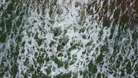 Aerial view of powerful ocean waves crashing on the shore with white foam and Stock Footage 317658426