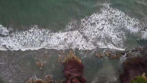 Aerial View of Powerful Ocean Waves Crashing Against Coastal Rocks Stock Footage 327011920