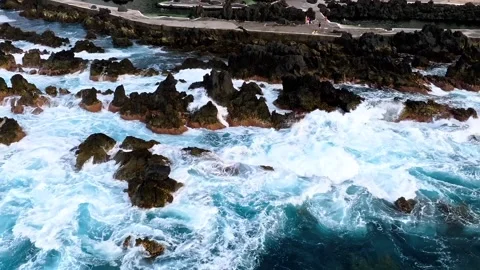 Aerial view of powerful ocean waves crashing against volcanic rocks shore. Stock-Footage 341071036