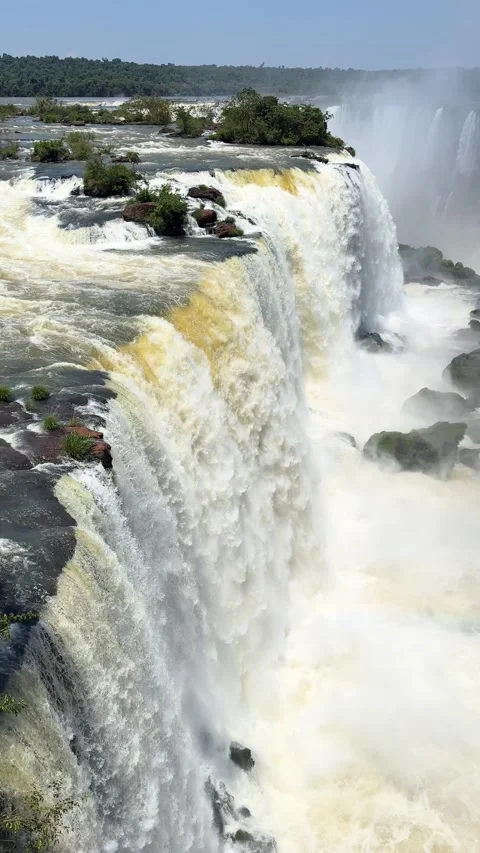 Aerial view of a powerful waterfall cascading over rugged cliffs surrounded by Stock Footage 276905694