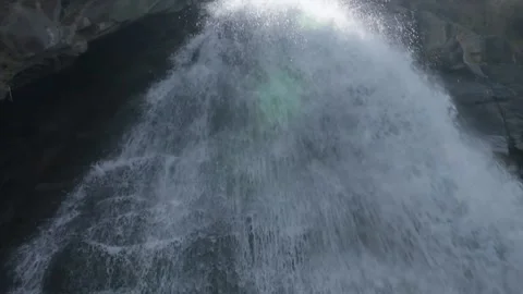 Aerial view of a powerful waterfall cascading down a rugged cliff face 스톡 동영상 314454564
