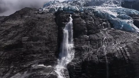 Aerial view of a powerful waterfall cascading from a melting glacier Stock Footage 318198060
