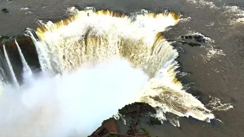 Aerial view of a powerful waterfall cascading over a rocky cliff edge . Stockbeeldmateriaal 342577194