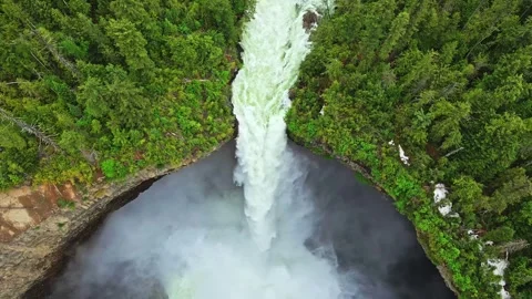 Aerial view of powerful waterfall cascading down cliff in forest Stock Footage 344137687