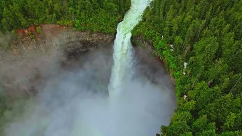 Aerial view of powerful waterfall cascading down cliff in forest Stock Footage 344137699