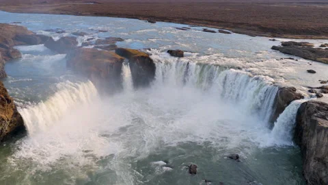 Aerial view of Powerful waterfall Godafoss pouring into a rocky basin. Iceland Stock Footage 337319145