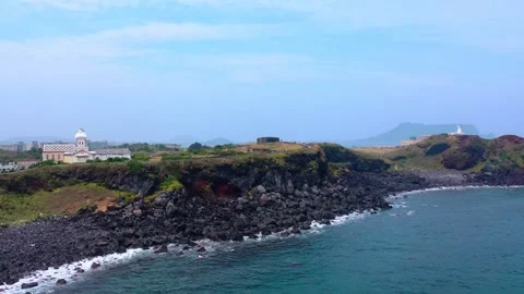 Aerial view of powerful waves crashing coastline of Jeju Island, South Korea Stock Footage 296559113