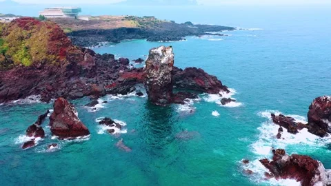 Aerial view of powerful waves crashing coastline of Jeju Island, South Korea Stock Footage 296559379