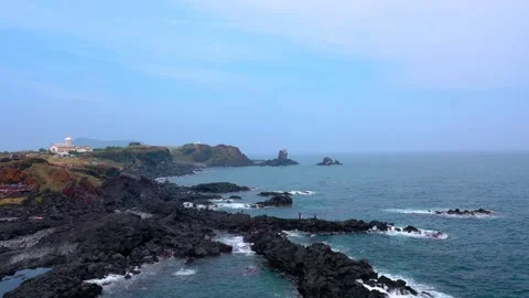 Aerial view of powerful waves crashing coastline of Jeju Island, South Korea Stock Footage 296560154