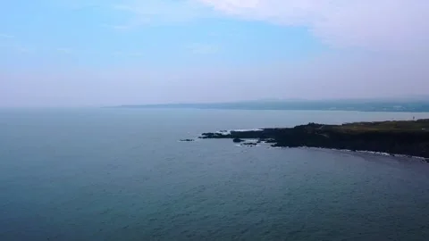 Aerial view of powerful waves crashing coastline of Jeju Island, South Korea Stock Footage 296562279
