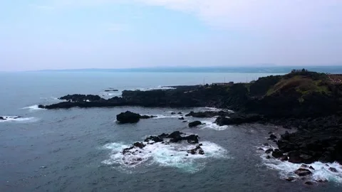 Aerial view of powerful waves crashing coastline of Jeju Island, South Korea Stock Footage 296563174