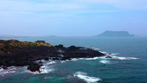 Aerial view of powerful waves crashing coastline of Jeju Island, South Korea Stock Footage 296563469