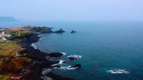 Aerial view of powerful waves crashing coastline of Jeju Island, South Korea Stock Footage 296563749