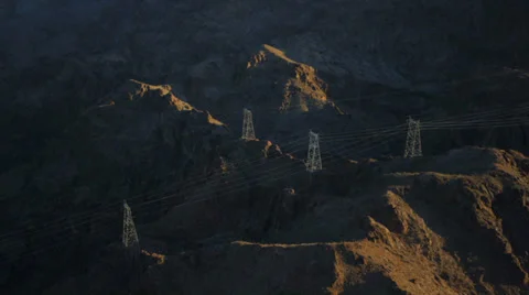 Aerial view of powerlines snaking through the mountains near the Hoover Dam. Stock Footage 34491582
