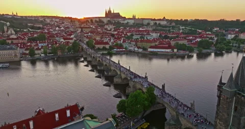 Aerial view of Prague Charles bridge and old town at sunset, over river. Czech Stock Footage 322516043