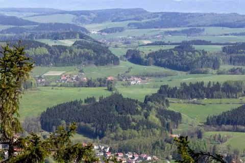 Aerial view presenting beautiful pattern of hills, fields, forests and villag Stock Photos