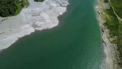 Aerial View of a Pristine Alpine Lake Nestled in the Scenic Austrian Alps D.. Stock Footage 317626538