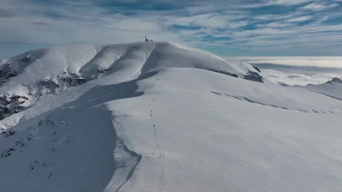 Aerial view of a pristine alpine mountain range covered in snow Stock Footage 297992319