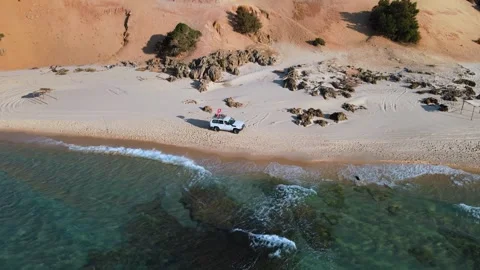 Aerial view of a pristine beach in Tunisia, with crystal-clear waters, a small Stock Footage 309611536