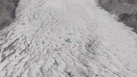 Aerial view of a pristine glacier in the mountains of Pakistan, highlighting the Stock Footage 314456892