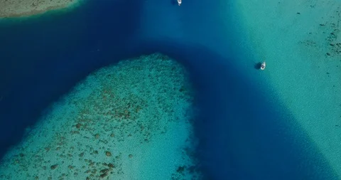 Aerial view of pristine lagoon and sailboat Stock Footage 115062200
