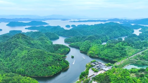 Aerial View of a Pristine Lake Dotted with Green Islands Among Mountain Scenery 스톡 동영상 341921235