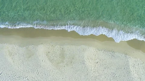 Aerial view of a pristine sandy beach with turquoise ocean waves Stock Footage 341908491