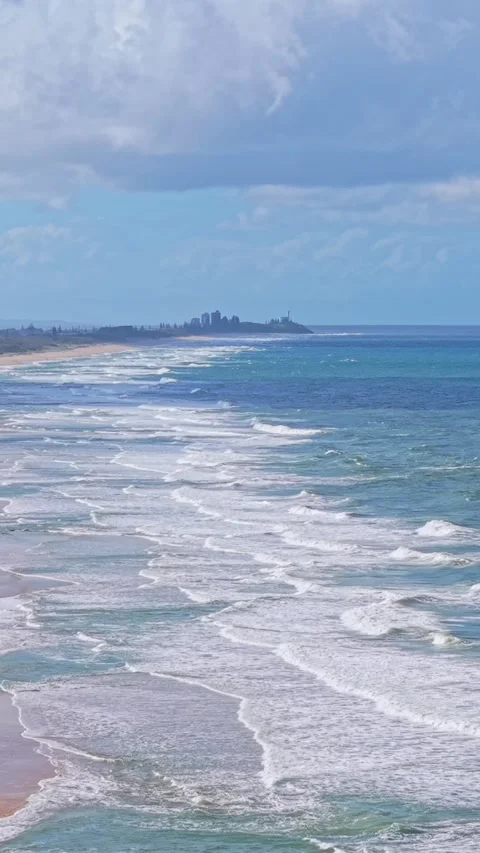Aerial view of pristine tropical beach coastline with waves and blue sky Stock-Footage 334784999