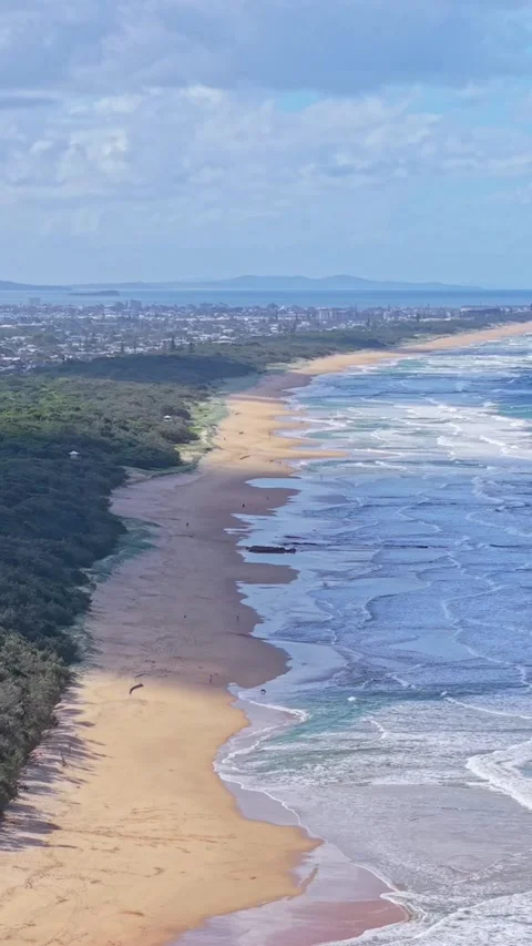 Aerial view of pristine tropical beach coastline with waves and blue sky Stock Footage 334785192