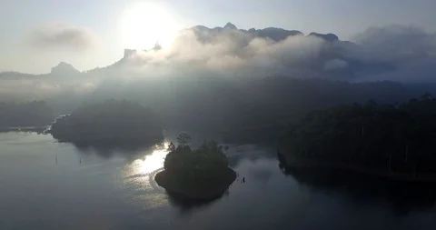 Aerial view of pristine tropical forest and lake, sun, Thailand 4k Stock Footage 121031818