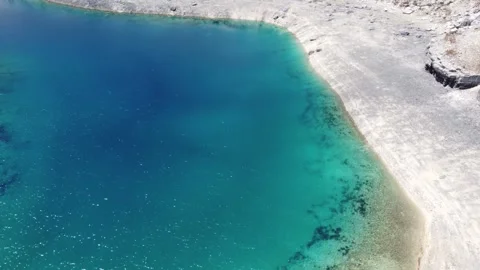 Aerial View of Pristine Turquoise Alpine Lake with Rocky Shoreline 스톡 동영상 347049686