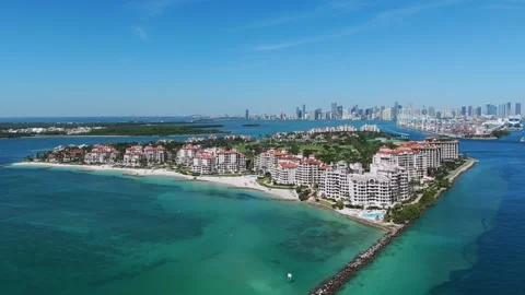 Aerial view of private island with multiple large buildings surrounded by clear Stock Footage 282260254