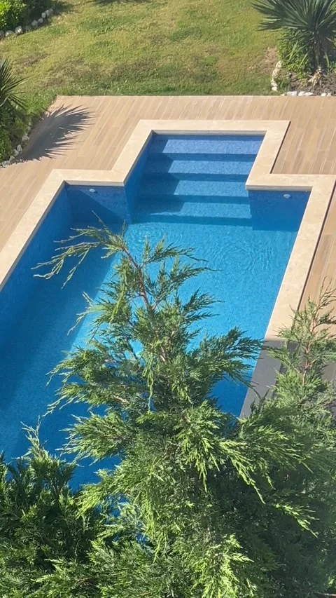 Aerial view of a private swimming pool in a garden by summer Stock Footage 334445081