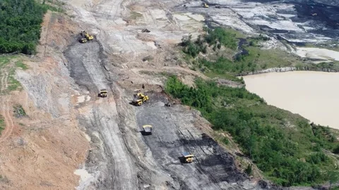 Aerial view of the process of loading and unloading trucks to build embankm.. Video stock 329401770