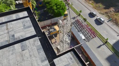 Aerial View: A professional crane operator climbs ladders and assembles parts Vídeo Stock 296021053