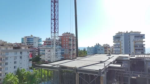 Aerial View: Professional operator assembles crane components, scaling ladders Vídeo Stock 296021905