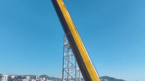 Aerial View: A professional operator scales ladders and assembles crane parts Vídeo Stock 296021842