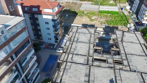 Aerial View: Professional operator scales ladders and mounts crane parts with Stock-Footage 296022265