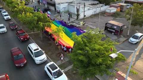 Aerial view of Progress Pride Flag in marching pride month of lgbtq Stock Footage 247187392