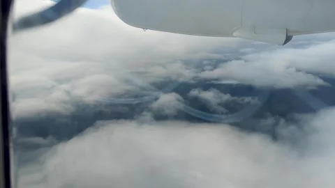 Aerial view from propeller airplane window flying through clouds in Fiji, South Stock Footage 339765463