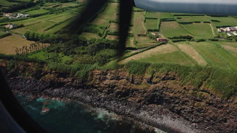 Aerial View from a Propeller Plane Window of Rugged Volcanic Cliffs, Patchwork Stock Footage 335010509