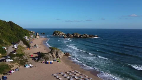 Aerial view of a public beach with deck chairs and tents Stock Footage 144592129