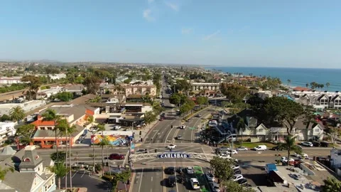 Aerial View Pull Back from Carlsbad Arch Sign and Coastal Village in California Stock Footage 333094413
