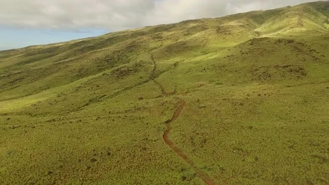 Aerial View Pull Back Over Dusty Trail In  A Green Valley. Stock-Footage 72653046