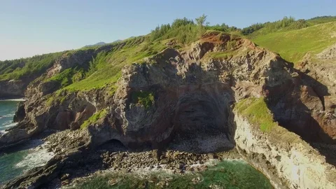 Aerial View Pull Out Of Rocky, Cliff Lined Beach With A Cave. Stock Footage 72525279